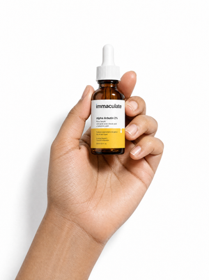 Hand holding the Immaculate Alpha Arbutin 2% Face Serum, showing its size and everyday form