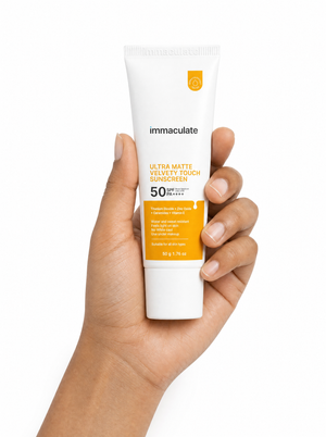 Hand holding the Immaculate Ultra Matte Velvety Touch Sunscreen, showing its size and everyday form