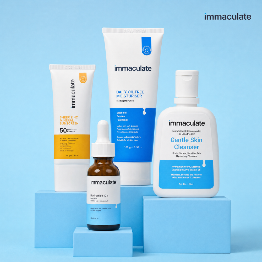 The Immaculate Everyday Essentials Kit — sunscreen, oil-free moisturiser, cleanser and serum on a blue studio set
